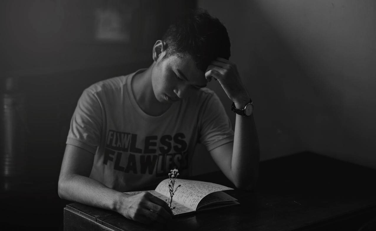 衬衫阅读笔记本中的灰度摄影