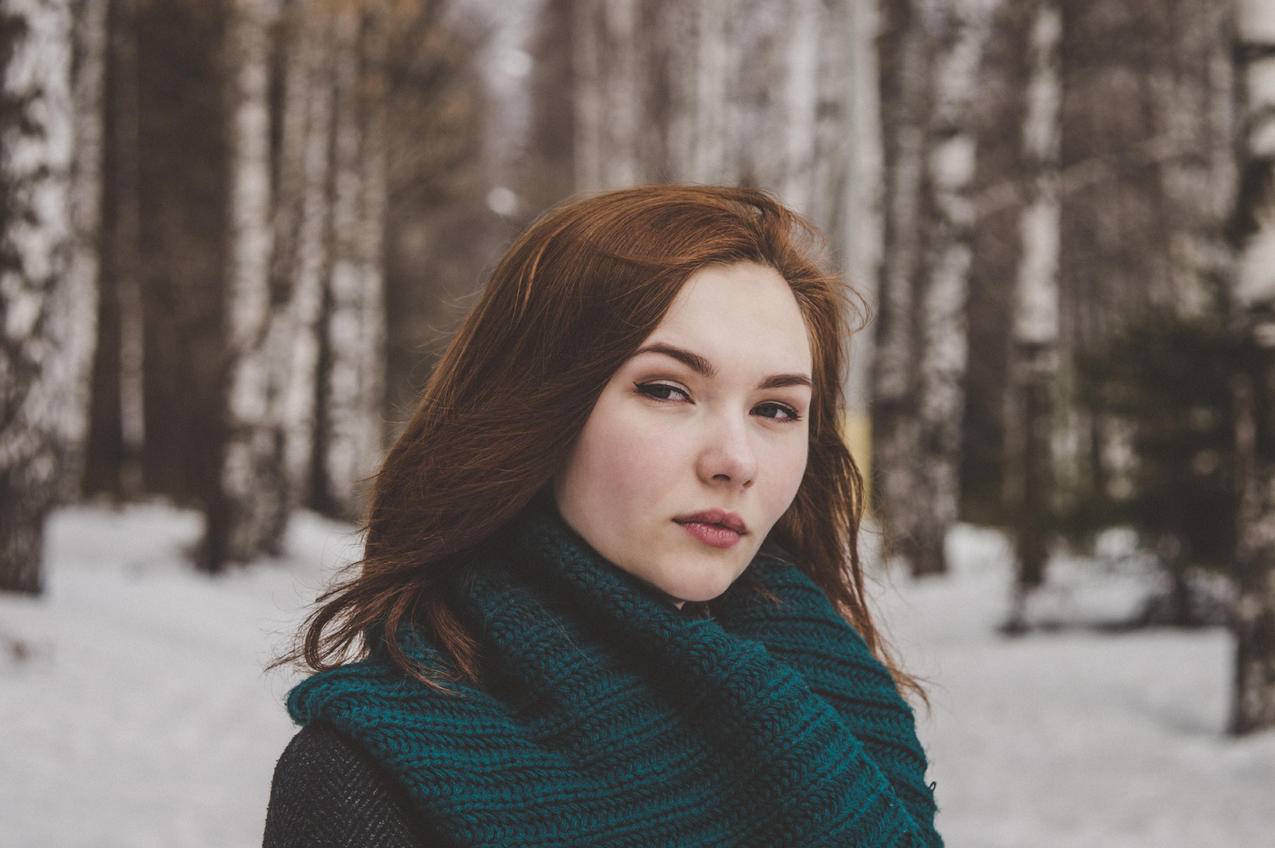 雪地上穿蓝色围巾妇女的选择性聚焦摄影