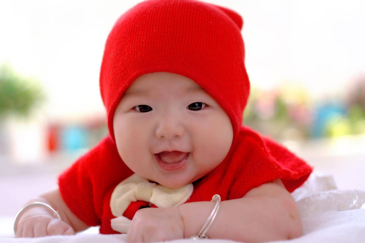 戴红色帽子的可爱的婴儿摄影图片